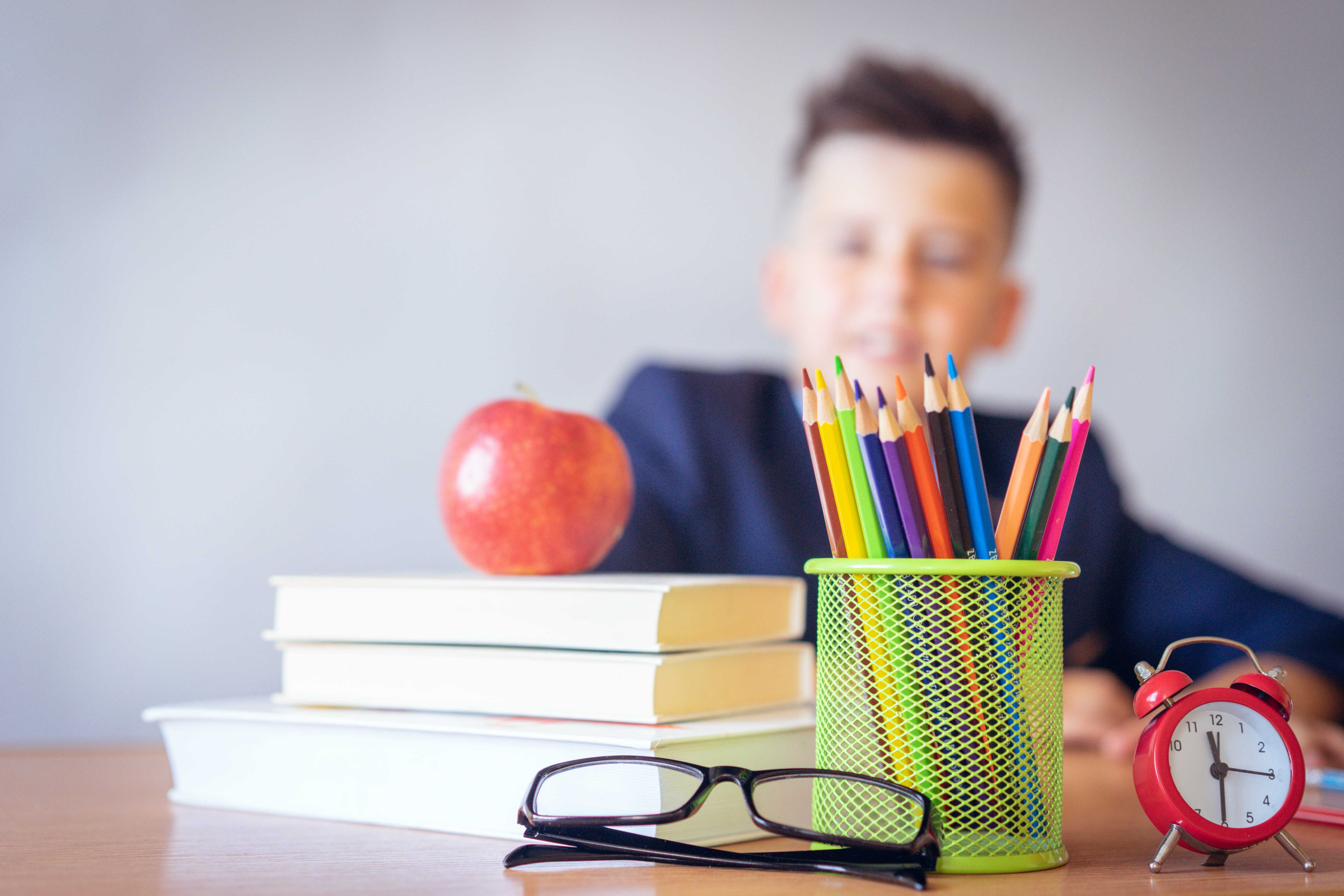 A photo of a child with school supplies.